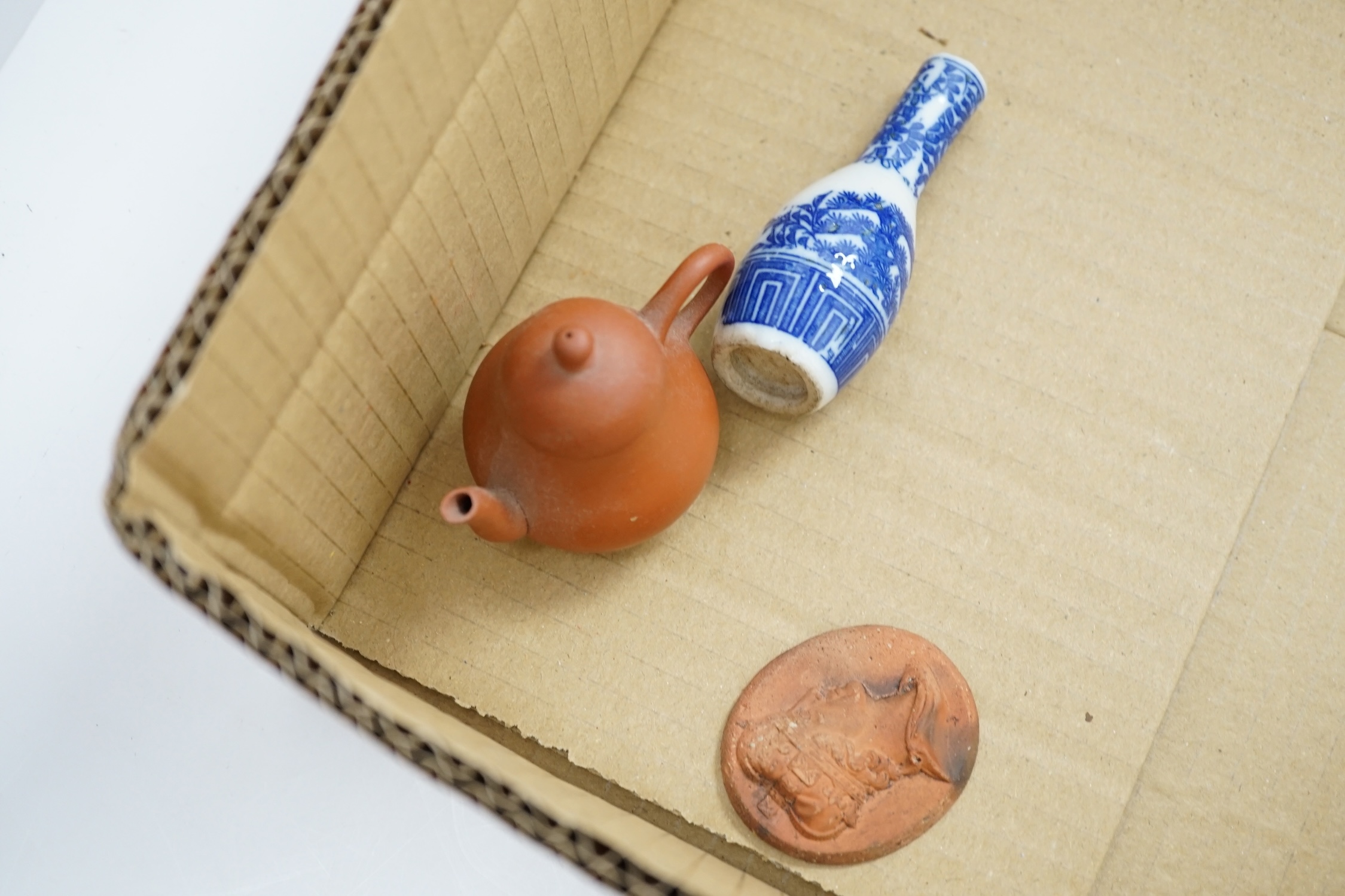 A collection of cabinet curiosities, including miniature cups, an ostrich egg, a Japanese marbled pottery teapot, a sand picture, snowmen cake decorations, etc. (2 trays). Condition - fair to good